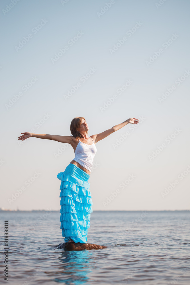 Woman enjoys on beach. Girl jumps on  waves and laughs. Model in swimsuit on  ocean vacation. Tourism and rest