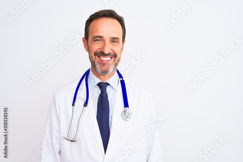 Middle age doctor man wearing coat and stethoscope standing over isolated white background with a happy and cool smile on face. Lucky person.
