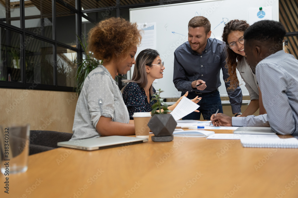 Multiethnic businesspeople brainstorm discussing ideas at team briefing