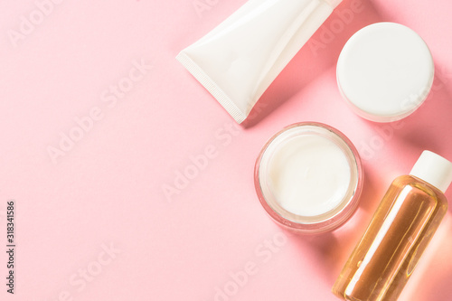 Natural cosmetic on pink flat lay.