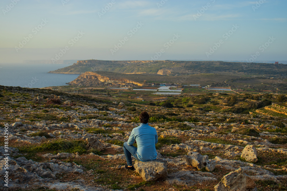 Man sitting and watching a beautiful scenery at Malta