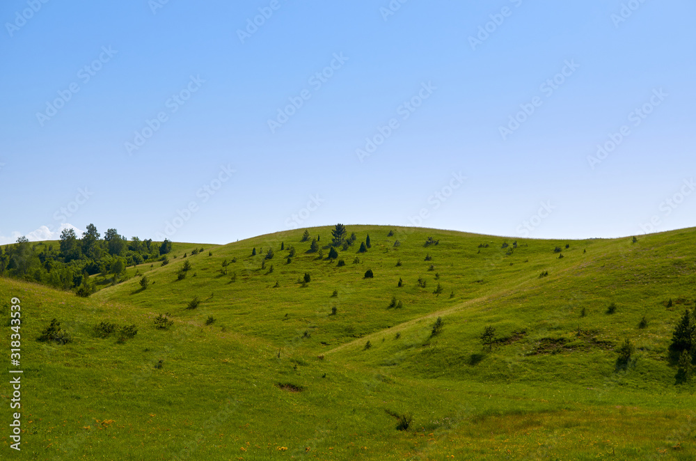 Idyllic mountain landscape - with green hills, pastures and fields Idyllic mountain landscape - with green hills, pastures and fields