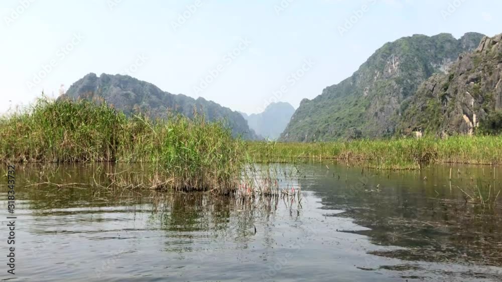 Landscape with boats in Van Long natural reserve in Ninh Binh, Vietnam, Full HD footage video Landscape with boats in Van Long natural reserve in Ninh Binh, Vietnam, Full HD footage video