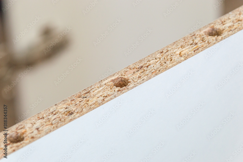 Hole in board chipboard for wooden peg. Hole in board chipboard for wooden peg.