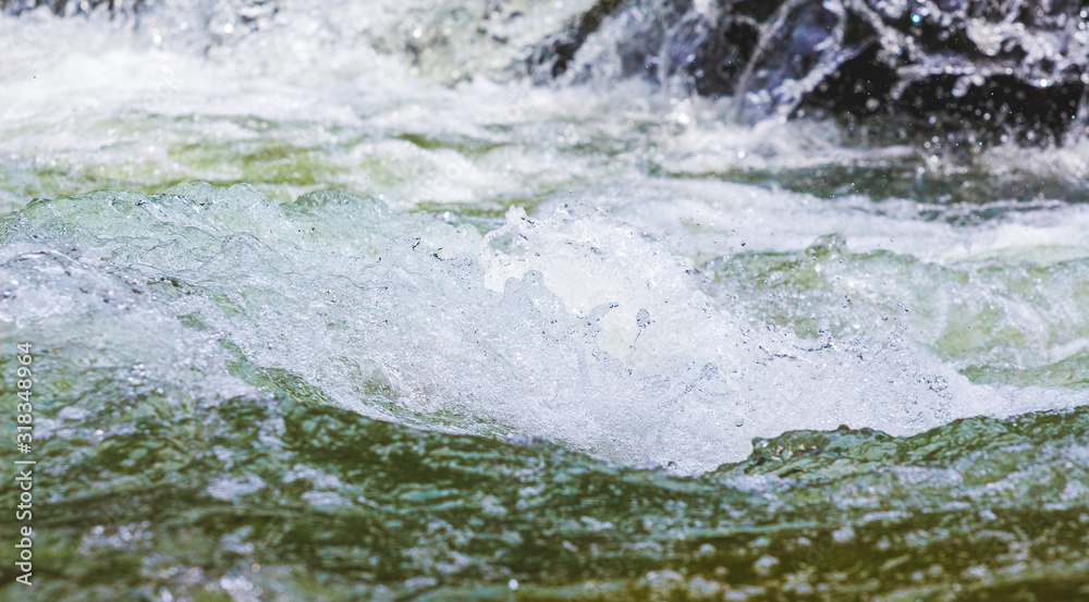 Obraz premium Stormy stream of water in a mountain river_
