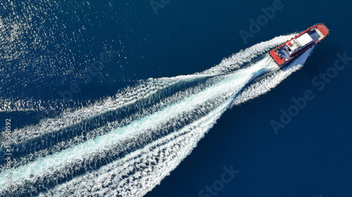 Aerial drone photo of pilot tug vessel cruising in Mediterranean container logistics port © aerial-drone