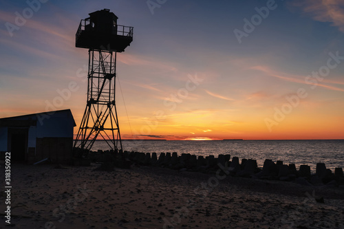 silhouette of a life-saving tower on the sea beautiful sunset on the background