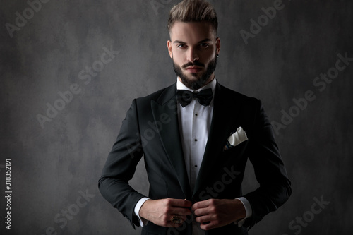 businessman holding hands on button and looking at camera