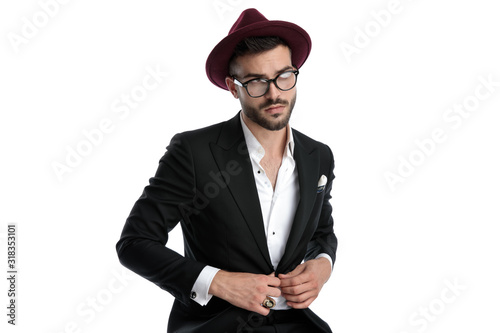 formal business man sitting and fixing jacket while dreaming photo