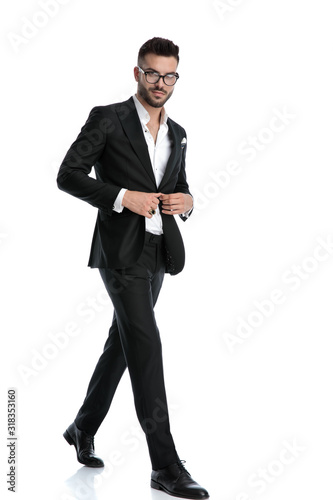 formal businessman walking and opening jacket happy photo