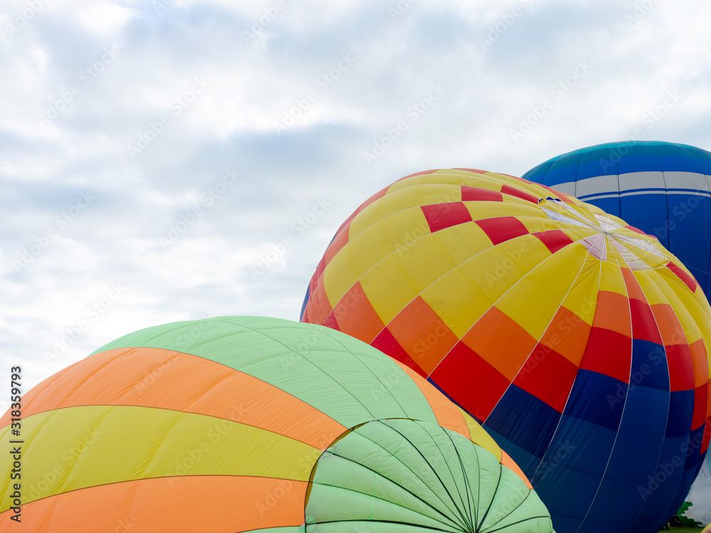 Fototapeta premium Balloons on the ground. Balloonists prepare the balloons for flight. Festival of aeronautics.