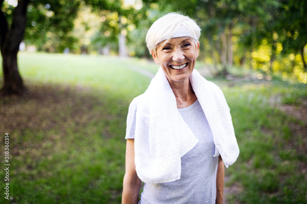Portrait of smiling sporty senior woman with towel outdoor Portrait of smiling sporty senior woman with towel outdoor