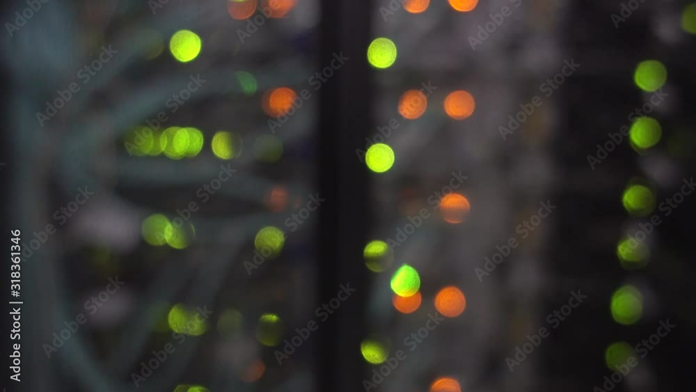Server rack with lots of flashing green and orange lights. Motion shot. Server rack with lots of flashing green and orange lights. Motion shot.