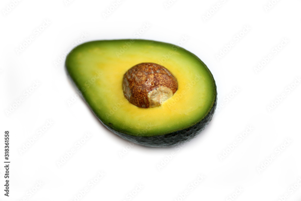 Half avocado with seed isolated on the white background.