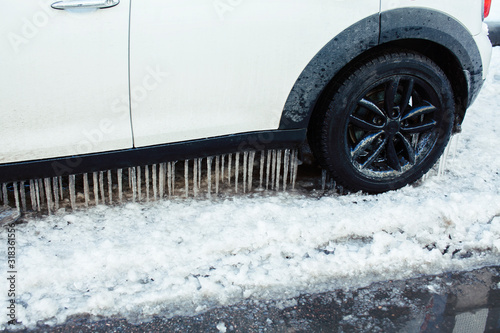 close up photo off car in iciles, a lot of water and snow, seasonal issues concept photo
