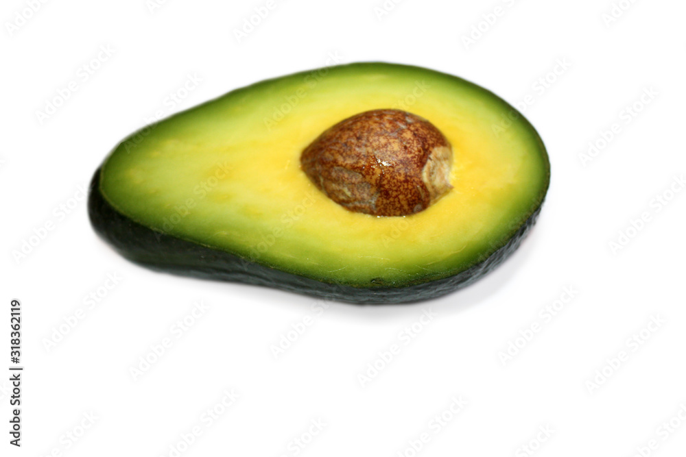 Half avocado with seed isolated on the white background.