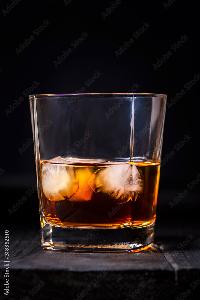 a glass of whiskey with ice