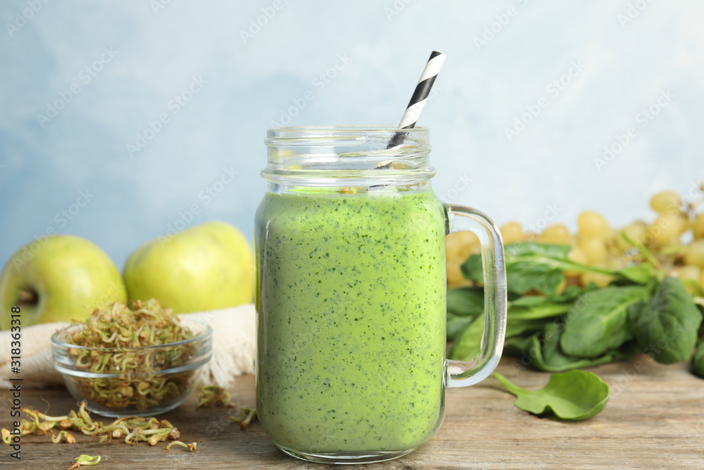 Tasty green buckwheat smoothie on wooden table Tasty green buckwheat smoothie on wooden table