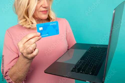 Woman using internet for online shopping with computer and credit card