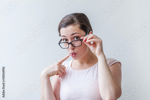 Beautiful happy girl smiling. Beauty simple portrait young smiling brunette woman in eyeglasses isolated on white background. Positive human emotion facial expression body language. Copy space