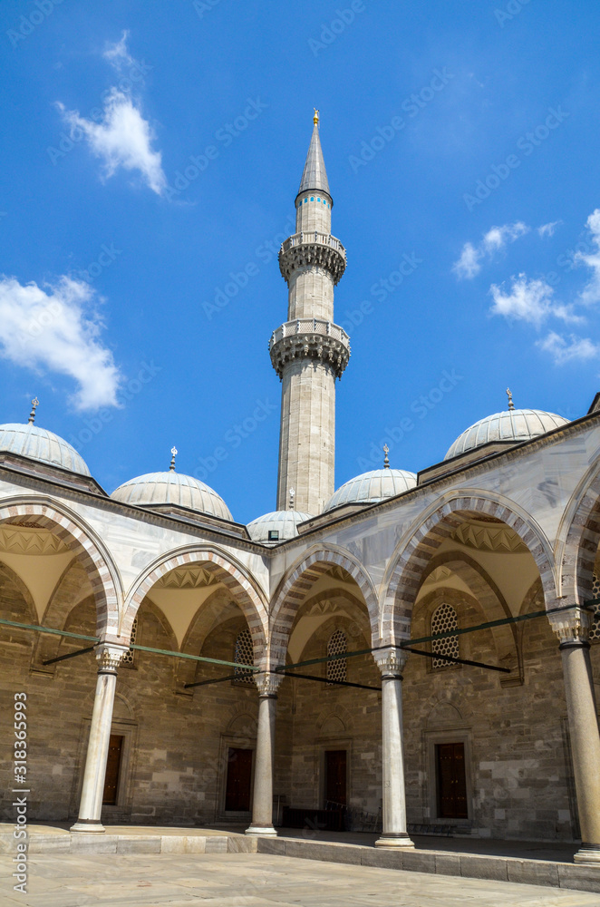 The view of inner courtyard surrounded by the arched gallery in Suleymaniye Mosque, Istanbul, Turkey 