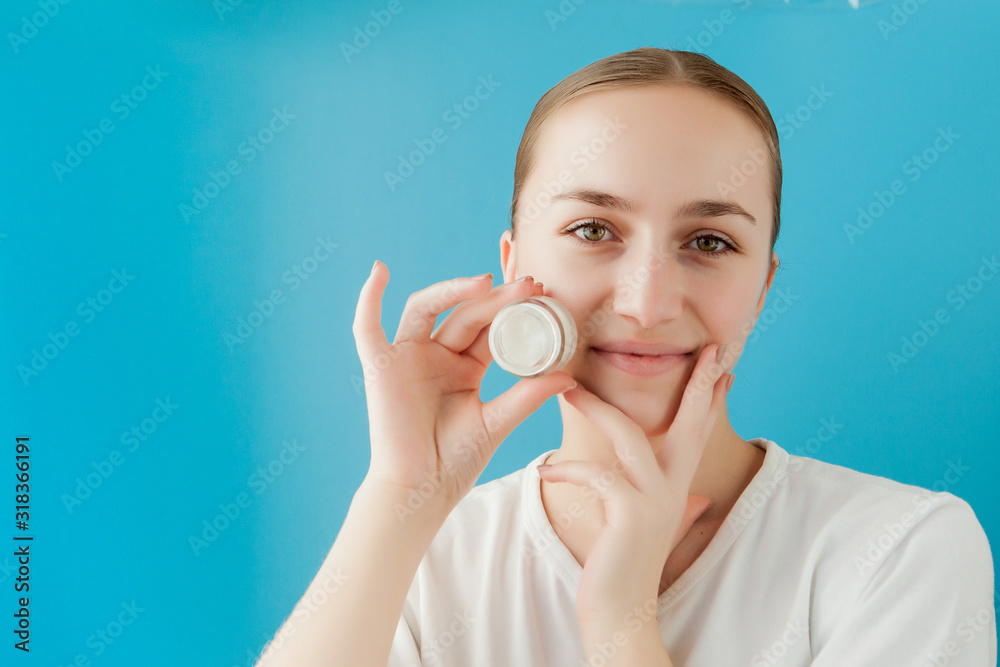 Portrait of joyful girl covering her eye by a cream can. She is looking at camera and laughing. Portrait of joyful girl covering her eye by a cream can. She is looking at camera and laughing.