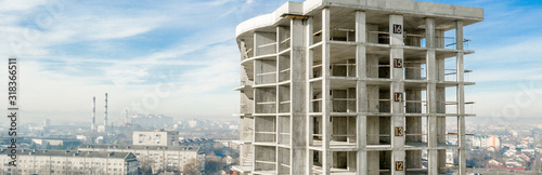 Panorama of Aerial view of concrete frame of tall apartment building under construction in a city