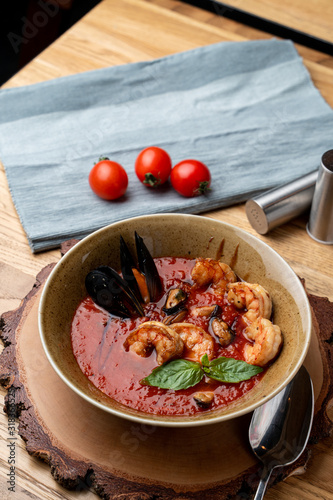 Hot and spicy tomato soup with king prawns and scallops and garlic