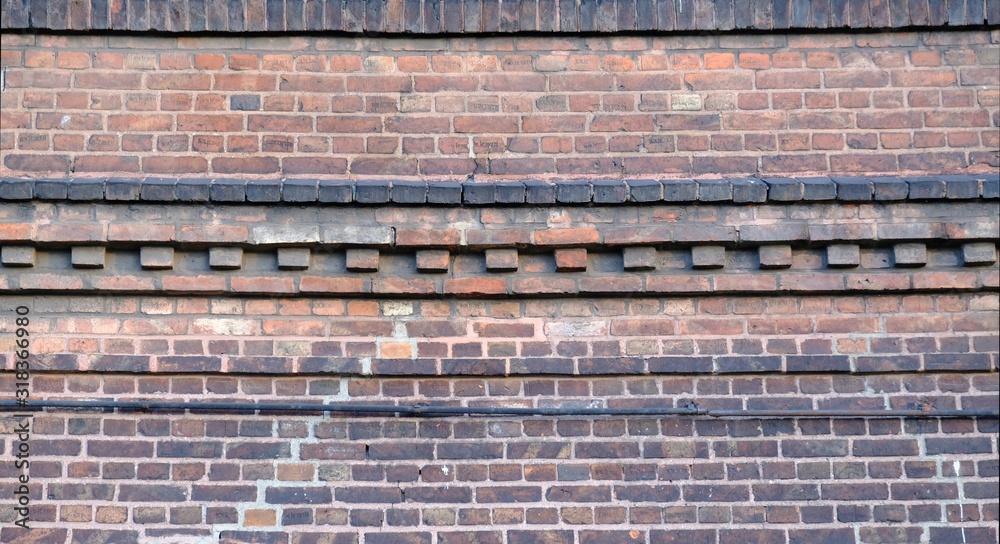 Old red brick facade of building - details of brick walls, cornice, arches Old red brick facade of building - details of brick walls, cornice, arches