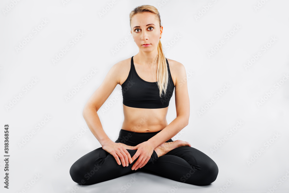 Sport blond girl in tracksuit for sport exercises on a white background Sport blond girl in tracksuit for sport exercises on a white background