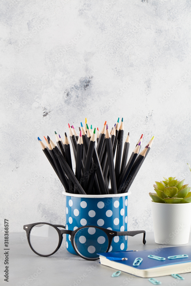 Work space school, office and business equipment concept with notebook, pencil, glasses, flowers Work space school, office and business equipment concept with notebook, pencil, glasses, flowers