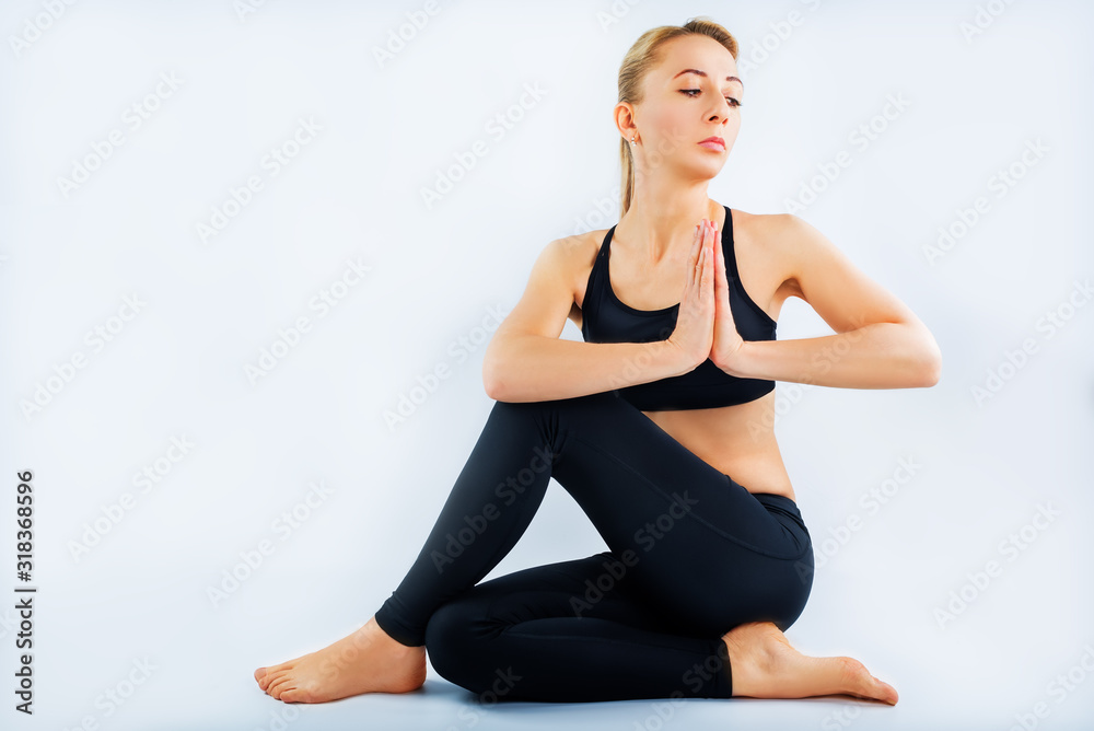 Sport blond girl in tracksuit for sport exercises on a white background Sport blond girl in tracksuit for sport exercises on a white background