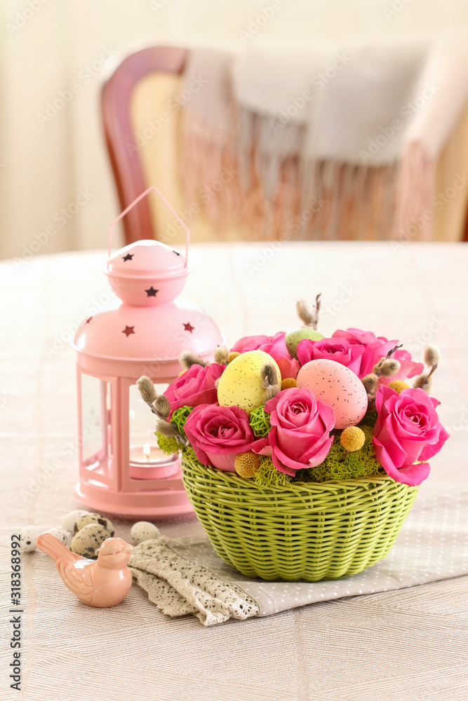 Woman shows how to make Easter table decoration with roses, moss and catkins, tutorial.