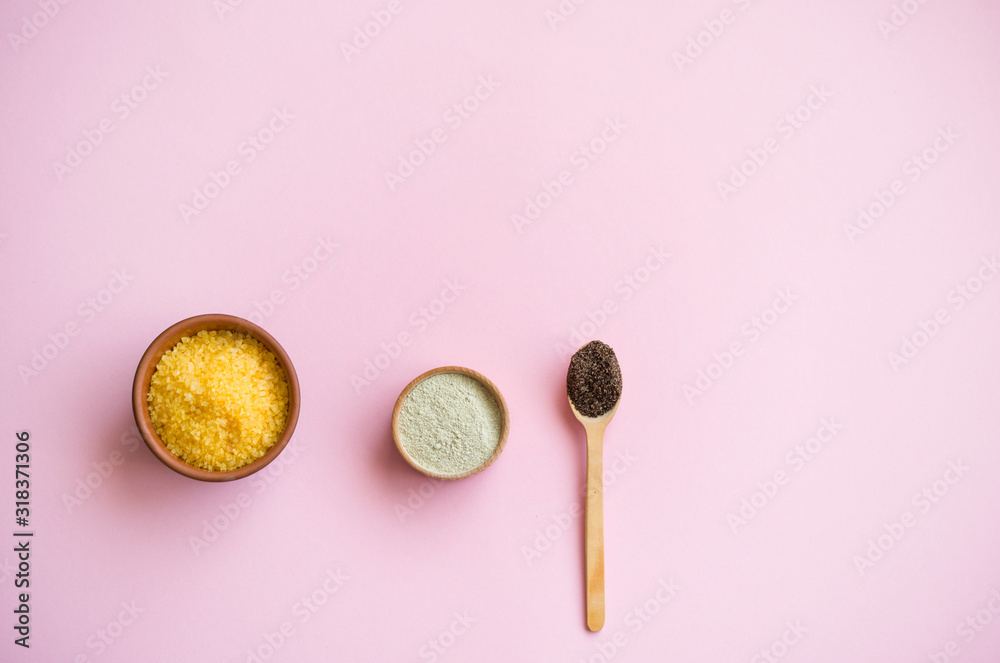 Cosmetic bath salt, grape gomaj for the face, coffee scrub for the body on a pink background. Cosmetic bath salt, grape gomaj for the face, coffee scrub for the body on a pink background.