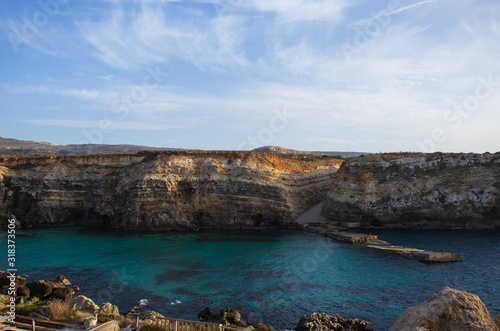 Panorama of the most beautiful bay in Malta with beautiful colorful sea and golden rocks