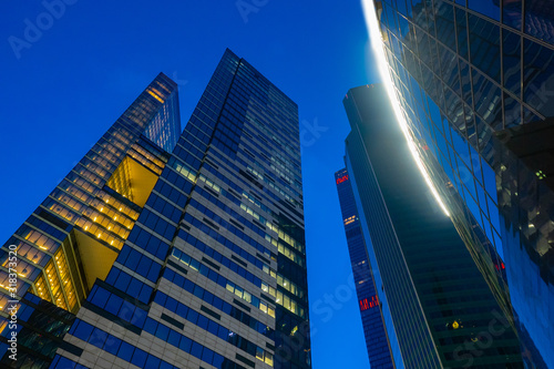Bottom view of high-rise buildings. Business part of the city in the evening. Modern urban architecture. Skyscrapers against the evening sky. Urbanistics. Office high-rise buildings. photo