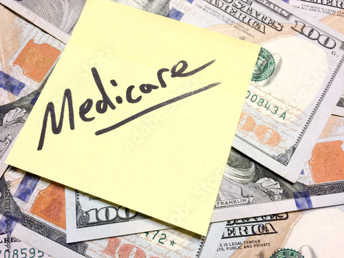 American cash money and yellow sticky note with text Medicare