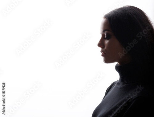 Portrait of woman with closed eyes on white background. Young female in profile. Free space for text.