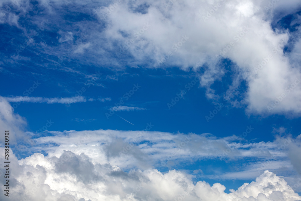 Airplane trail in the blue cloudy sky. Airplane trail in the blue cloudy sky.
