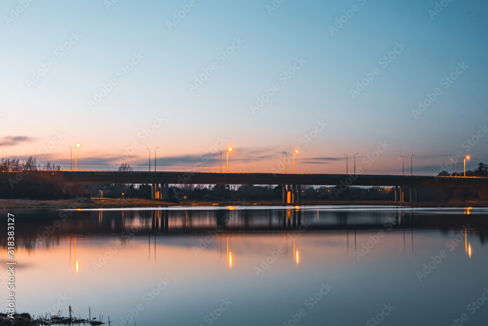 A Bridge At A Blue Hour With Reflections In The Lake.