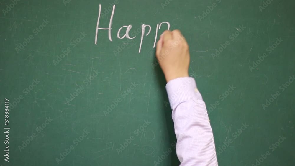 Hand writes HAPPY FATHER'S DAY on a chalkboard Hand writes HAPPY FATHER'S DAY on a chalkboard