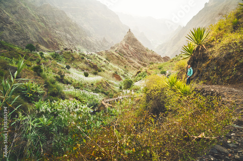 Santo Antao Island, Cape Verde. Traveler man on hike path in Ribeira da Torre. Mountain ridge and ravine on the cobbled path to Xo-Xo Valley photo