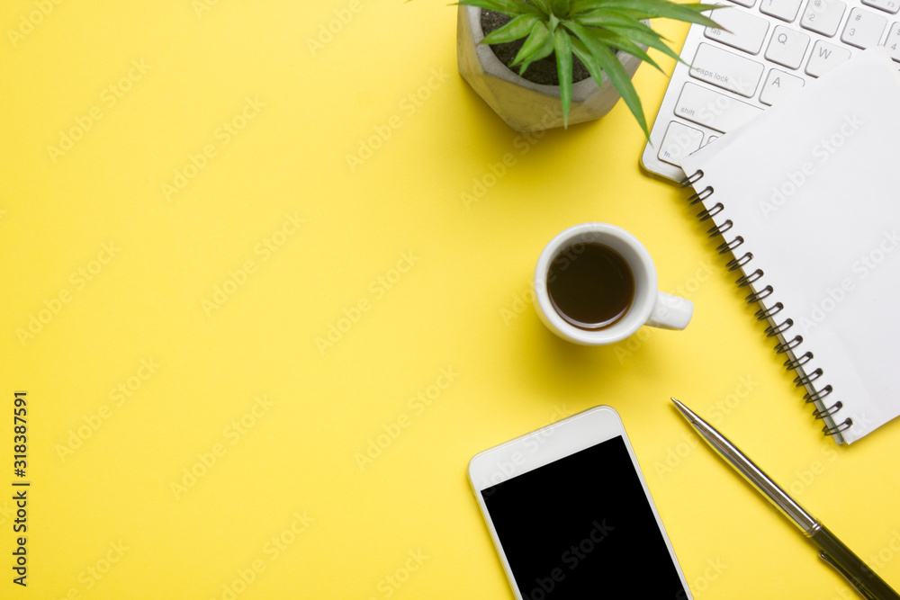 Yellow desk office with laptop, smartphone and other work supplies with cup of coffee. Top view with copy space for input the text. Designer workspace on desk table essential elements on flat lay - obrazy, fototapety, plakaty 