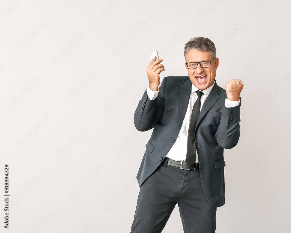Happy businessman with mobile phone on white background Happy businessman with mobile phone on white background