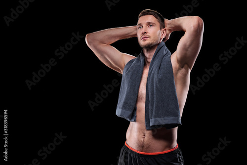 Handsome muscular shirtless male athlete keeping his hands on backhead photo