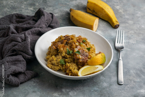 Fufu de platano verde maduro, tacaho, Mofongo, mashed  boiled plantains with porc meat, onion. Puerto Rico.  Amazonian cuisine, Peru, Cuba photo