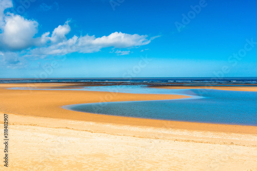 Tide pool of water at low tide on Barnham Overy Staithe beach