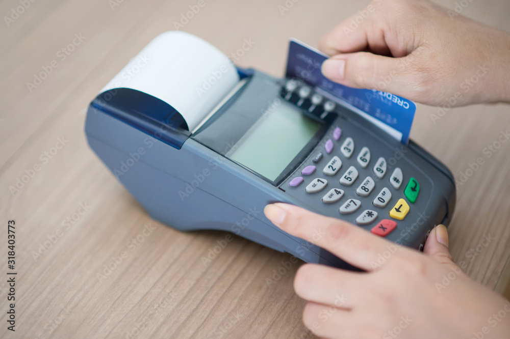 Close-up, focusing on capturing credit card payments, swiping credit cards, not using cash concept Close-up, focusing on capturing credit card payments, swiping credit cards, not using cash concept
