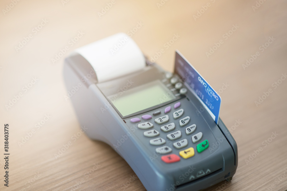 Close-up, focusing on capturing credit card payments, swiping credit cards, not using cash concept Close-up, focusing on capturing credit card payments, swiping credit cards, not using cash concept