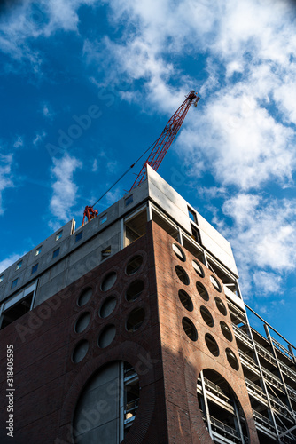 Linear geometric blue sky Crane building construction big urban red brick uk